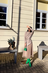 a lady in an asymmetrical top and a brown tulle skirt